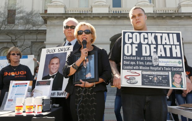Tammy Smick, center, flanked by her husband, Tim left, and son, Chris, called on the Medical Board of California to crack down on doctors whose overprescribing of medications has led to death or serious injuries during a rally at the Capitol in Sacramento in 2013. The Smicks, whose other son, Alexander, died after an overdose of a drug prescribed by a doctor, were among several families that testified before s joint legislative committee looking into whether to reauthorize the physician-run board. (AP Photo/Rich Pedroncelli)