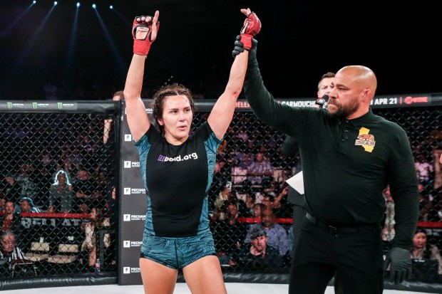 Cat Zingano, with her hand being raised by referee Frank Trigg, won a hard-fought, back-and-forth featherweight bout against Leah McCourt at Bellator 293 on March 31, 2023, at Pechanga Resort Casino in Temecula. (Bellator MMA/Lucas Noonan)