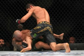 A head kick by the 155-pound king drops the featherweight champ, followed by several unanswered punches for a first-round TKO on Saturday in Abu Dhabi