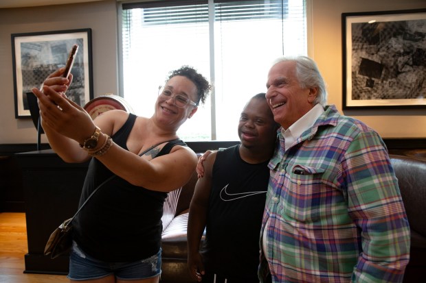 Fans take a photo with actor Henry Winkler.