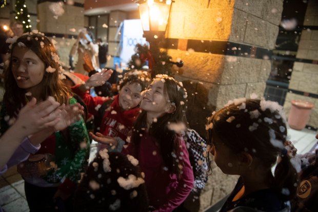 Vera Thomson, 9, of Rancho Mission Viejo, center, enjoys the fake snow during the annual City of Irvine Christmas tree lighting event in Irvine on Saturday, Dec. 7, 2019. (Photo by Kevin Sullivan, Orange County Register/SCNG)