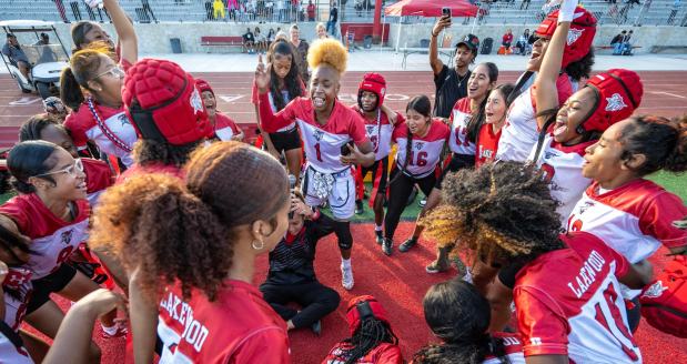 The Lakewood High girls flag football team chants before a game against Jordan High on Wednesday, Oct. 25, 2023, in Lakewood. Lakewood went on to win the game. (Photo by Mark Rightmire, Orange County Register/SCNG)