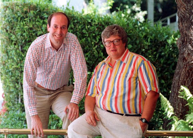 Roger Ebert, right, poses with Gene Siskel in Los Angeles in this 1986 photo. Matt Singer's new book, 'Opposable Thumbs: How Siskel & Ebert Changed Movies Forever,' reveals how the Chicago film reviewers became a phenomenon. (AP Photo/DOUGLAS C. PIZAC)