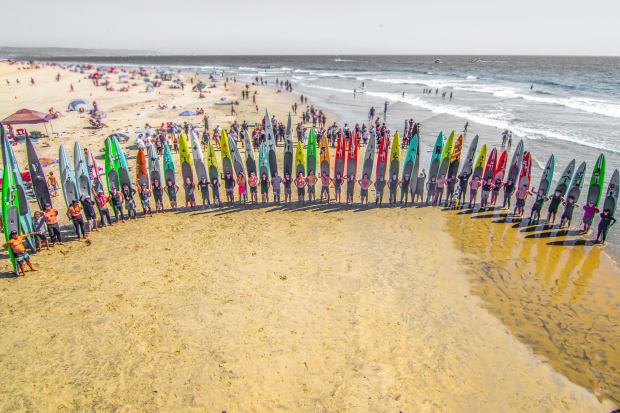 A group shot of all the paddlers after they finish the 30-mile "Ben Did Go" paddle in 2021 from Catalina to Newport Beach. This year, more than 100 prone paddlers are expected to do the grueling trek. (Photo courtesy of Tom Cozad)