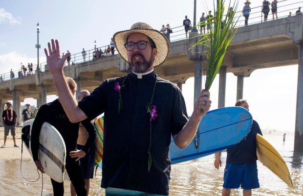 The Rev James Pike of Lutheran Church of the Resurrection, takes part in the annual Blessing of the Waves service in Huntington Beach in 2019. (Photo by Mindy Schauer, Orange County Register/SCNG)