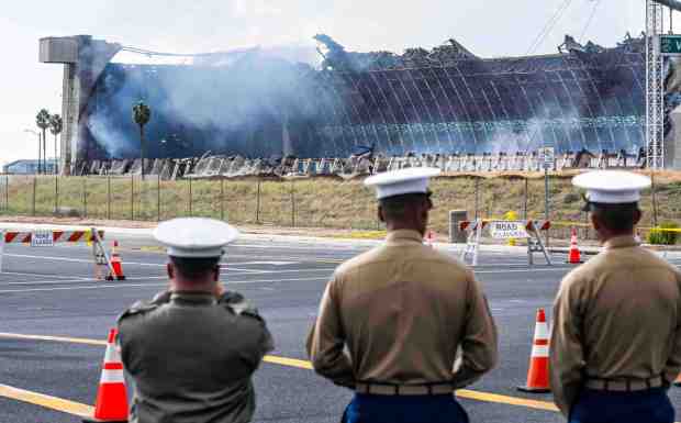 Marines watch as Orange County firefighters battle a fire affecting the north hangar at the Tustin Air Base in Tustin on Tuesday, November 7, 2023. (Photo by Paul Bersebach, Orange County Register/SCNG)