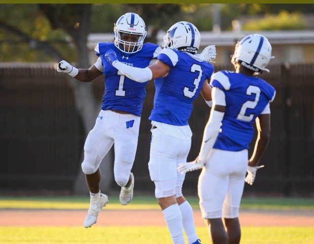 Western running back Josh Faulkner (1) celebrates with teammates scoring a touchdown against Los Alamitos in the first quarter in a non-league football game in Anaheim on Friday, August 18, 2023. (Photo by Paul Rodriguez, Contributing Photographer)
