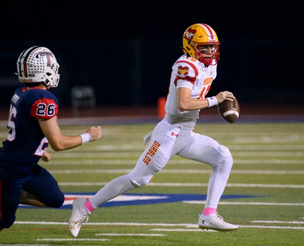 Mission Viejo quarterback Draiden Trudeau scrambles away from Tesoro linebacker Adam Achour in a South Coast League football game in Las Flores on Friday, October 20, 2023. (Photo by Paul Rodriguez, Contributing Photographer)