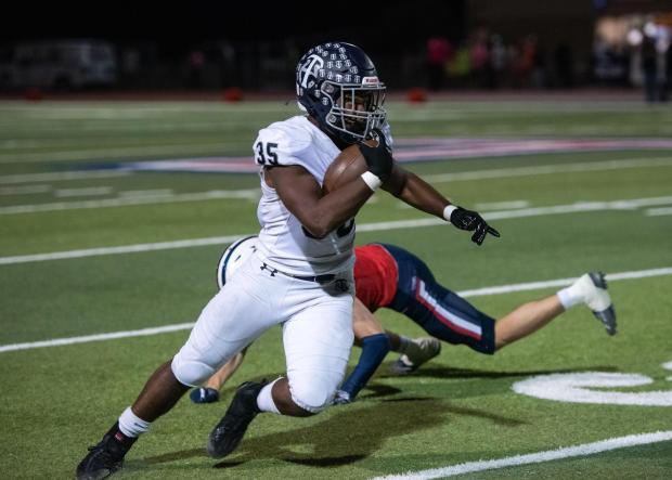 Trabuco Hills running back Taylor Bowie dodges Tesoro defenders while carrying the ball during a nonleague game between the two teams on Friday, October 6, 2023. (Photo by Jeff Antenore, Contributing Photographer)