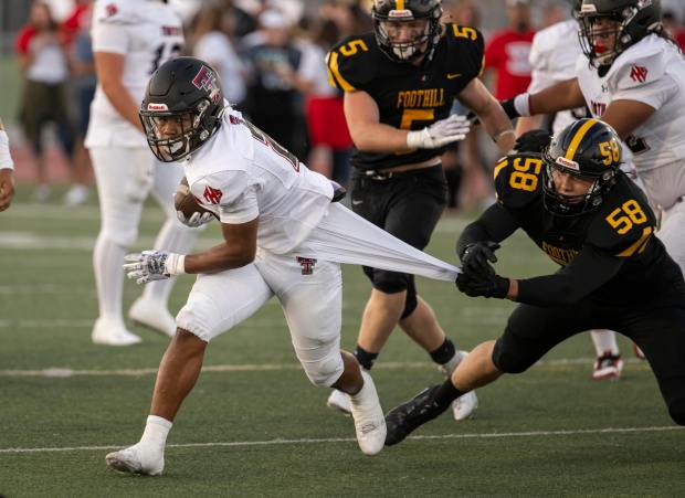 Tustin, including standout running back Eimesse Essis, left, continues to climb in the Orange County football top 25. The undefeated Tillers are at No. 11 this week. (Photo by Paul Rodriguez, Contributing Photographer)
