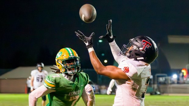 Mack Alleyne (3) of Tustin reaches up to catch a pass for a touchdown over the defense of Kennedy's Drew Deese (7) during an Empire League football game at Western High School in Anaheim on Thursday, September 28, 2023. (Photo by Leonard Ortiz, Orange County Register/SCNG)