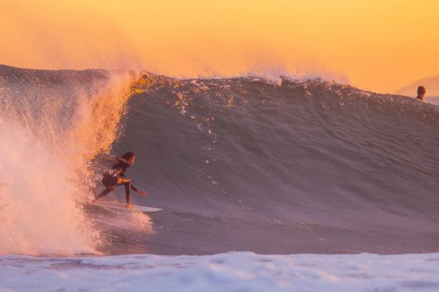 Crowds gathered at a surf spot in Newport Beach south of the pier saw solid overhead sets as the hurricane swell approached Saturday, Aug. 19, 2023 with a colorful sunset lit up the sky. (Photo courtesy of Tom Cozad)