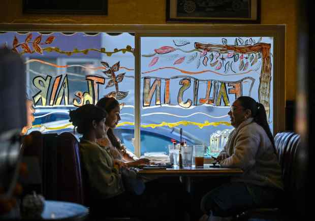 Melanie Quezada, left, Leslie Ramirez, center, and Victoria Quezada eat at The Filling Station in Orange, CA, on Thursday, November 2, 2023. (Photo by Jeff Gritchen, Orange County Register/SCNG)