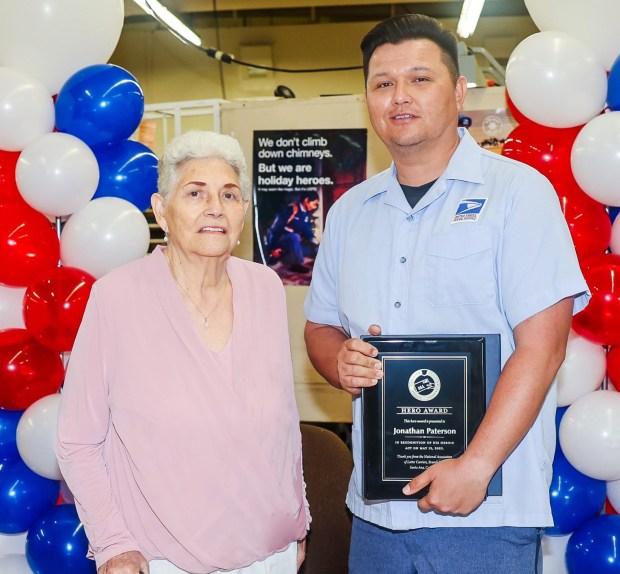 Fountain Valley letter carrier Jonathan Paterson was awarded the Postmaster General Hero Award after helping Maria Chavez, left, a customer who had fallen and couldn't get up. (Courtesy of USPS)