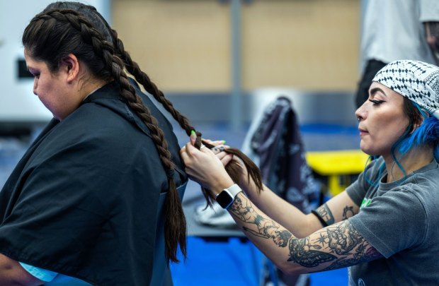 Stylist Brenna McCarthy braids the hair of CSUSB student Stephanie Aguirre after styling it during the second annual Queer Cuts at Santos Manuel Student Union Conference Center on the Cal State San Bernardino campus in San Bernardino on Wednesday, Oct. 18, 2023. (Photo by Terry Pierson, The Press-Enterprise/SCNG)
