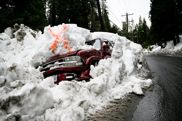 A totaled SUV is covered by snow along the streets of Crestline on Monday, March 6, 2023. (File photo by Anjali Sharif-Paul, The Sun/SCNG)