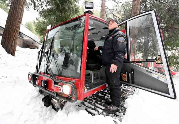 San Bernardino County Fire Department Capt. Don Whitesell stands on the treads one of the department's eight Snowcats in Lake Arrowhead on Friday, March 10, 2023. (File photo by Will Lester, Inland Valley Daily Bulletin/SCNG)