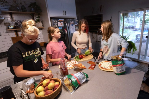 Soon after the Camp Fire destroyed most of her childhood hometown of Paradise, Jen Goodlin, second from right, returned from suburban Colorado Springs to raise her daughters, from left, Norah, 14, Sarah, 12, and Maya, 15, and help the community rebuild. Because so few homes were available, the family lived in a trailer for more than two years while they custom-built a new house. (Karl Mondon/Bay Area News Group)