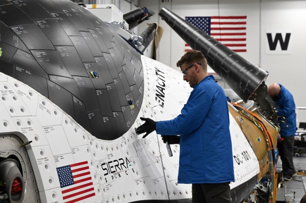 Engineering technician Alaric Hoffmeier works on the thermal protection system tiles on the side of the Dream Chaser at Sierra Space on October 30, 2023 in Louisville, Colorado. Sierra has doubled its workforce, from 1,000 to 2,000, over the past year. Its centerpiece effort right now is the Dream Chaser, which harks back to the space shuttle design. (Photo by Helen H. Richardson/The Denver Post)